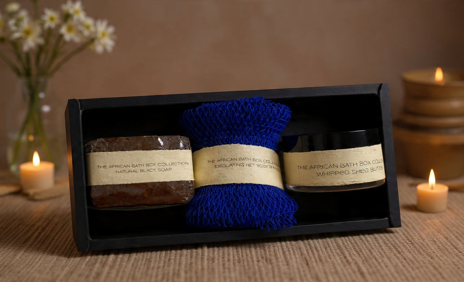 Gift set with bath products including a African exfoliating sponge, African black  soap, and creamy whipped natural shea butter